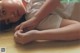 A woman laying on the floor with her hands on her knees.