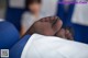 A close up of a person's feet on a blue chair.