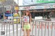 A woman standing in the middle of a city street.