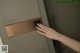 A woman's hand is pressing a button on a door.